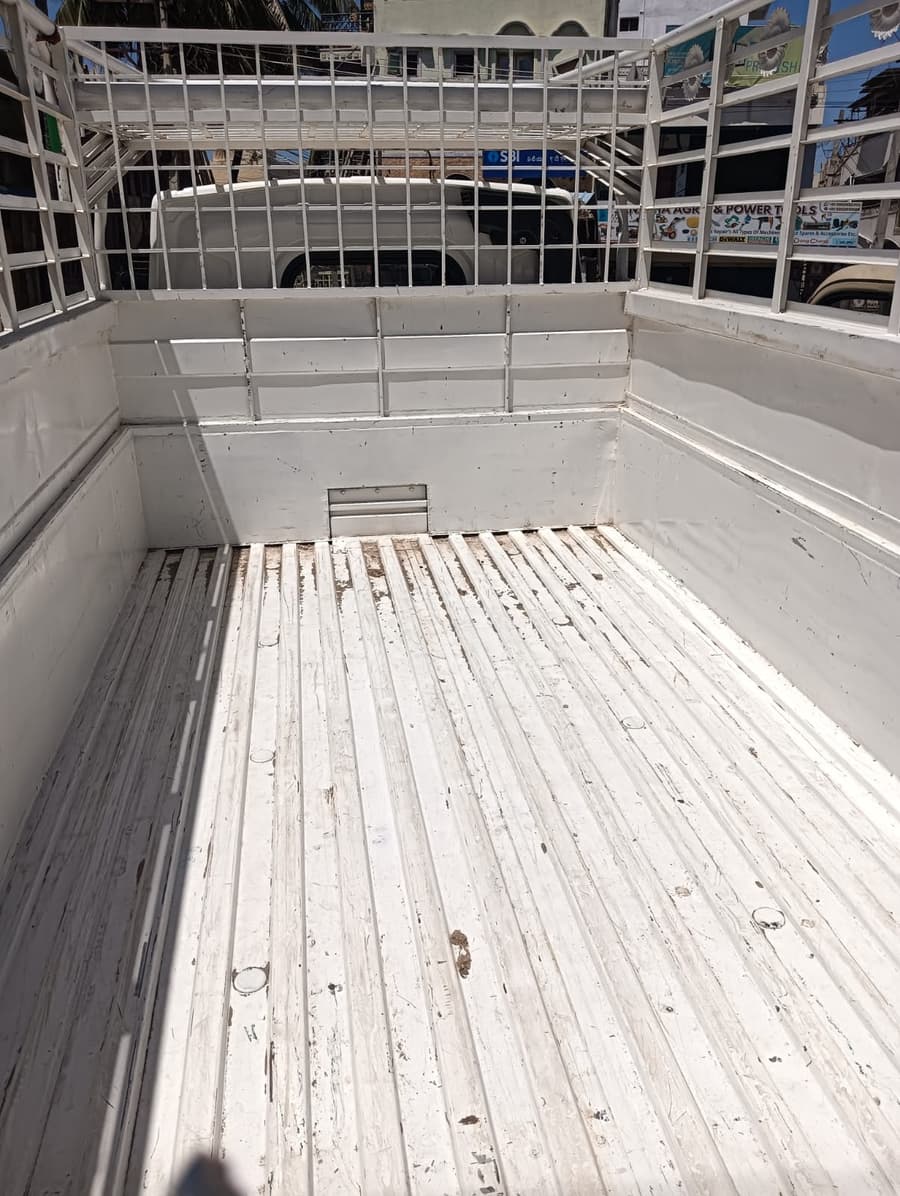 Empty cargo bed of the Al-Qaswa Transports vehicle, ready to load